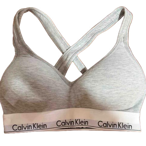 Calvin Klein bra on a website with 'Hacer oferta' and 'Comprar ah' buttons.